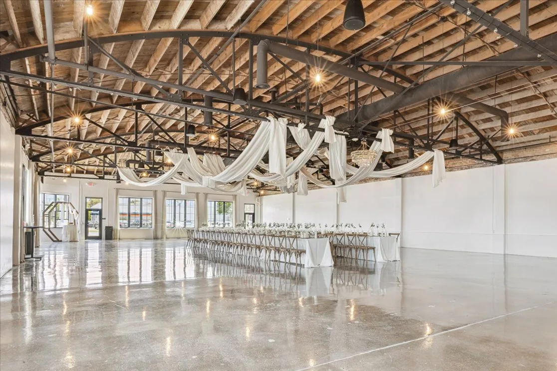 The same building after renovation, with polished concrete floors and an open wood and steel ceiling